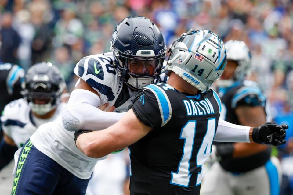 Seattle Seahawks safety Julian Love (20) hits Carolina Panthers quarterback Andy Dalton (14) following a pass attempt by Dalton during the first quarter at Lumen Field. Love was given a penalty on the play.