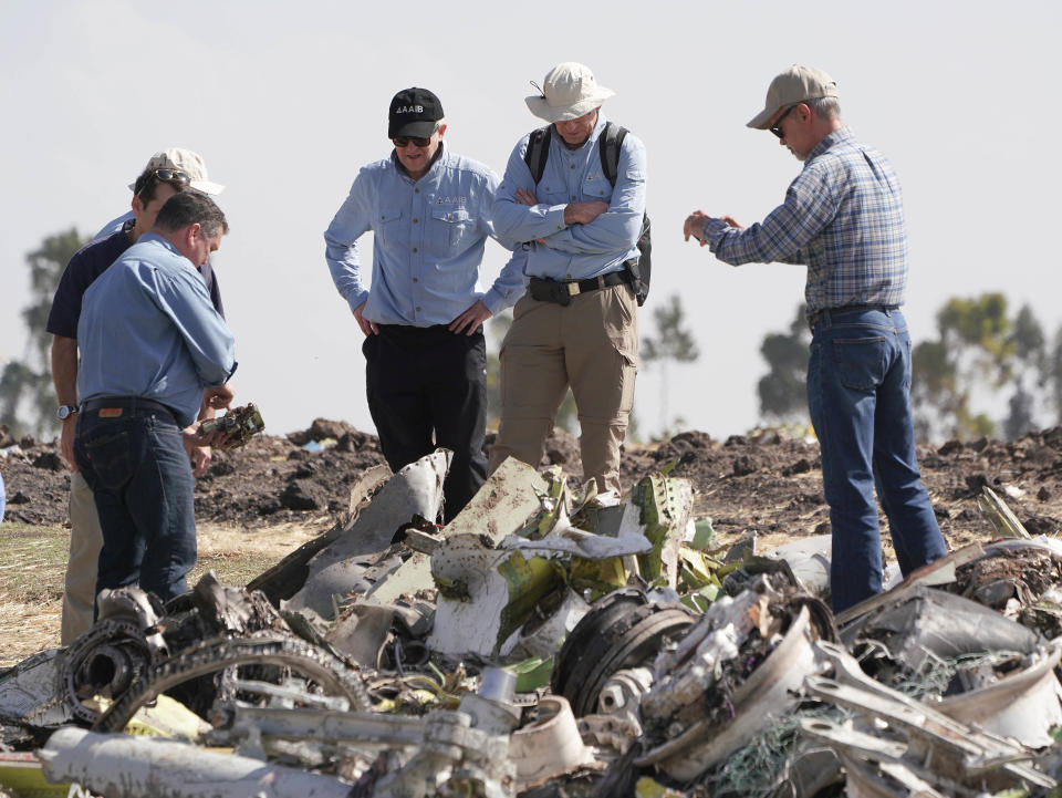 Investigators with the U.S. National Transportation and Safety Board look over debris at the crash site of Ethiopian Airlines Flight 302 on March 12, 2019, in Bishoftu.