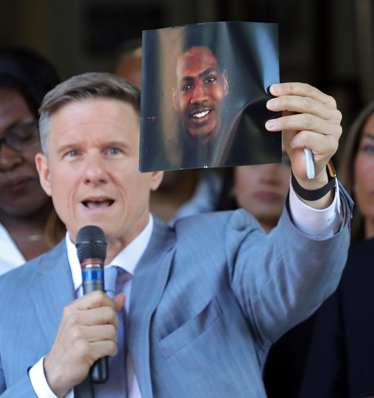 Attorney Bobby DiCello holds up a photograph of Jayland Walker, the man who was shot dead by Akron Police on Monday, June 25, as he speaks on behalf of the Walker family during a press conference at St. Ashworth Temple on Thursday.