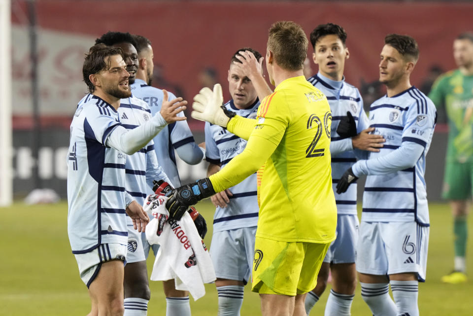 Sporting Kansas City goalkeeper Tim Melia (29) celebrates with teammates after defeating Toronto FC in an MLS soccer game in Toronto, Ontario, Saturday, March 30, 2024. (Frank Gunn/The Canadian Press via AP)