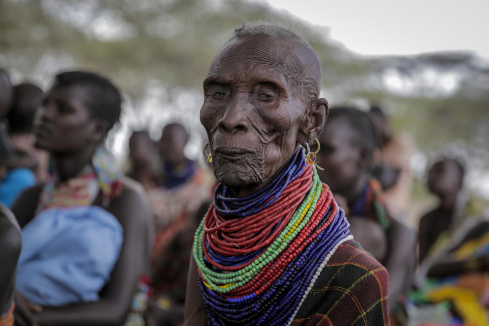 Villagers gather during a visit by United Nations Under-Secretary-General for Humanitarian Affairs Martin Griffiths, in the village of Lomoputh in northern Kenya Thursday, May 12, 2022. Griffiths visited the area on Thursday to see the effects of the drought which the U.N. says is a severe climate-induced humanitarian emergency in the Horn of Africa. (AP Photo/Brian Inganga)