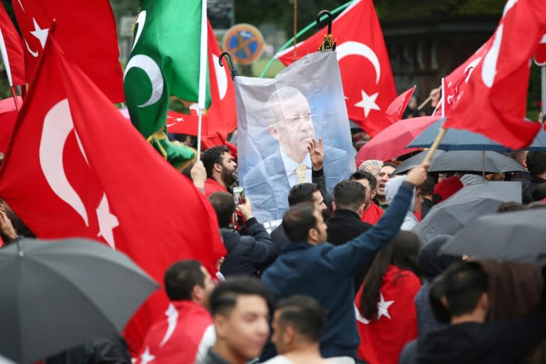 Members of Germany's Turkish community gather in front of the Turkish Consulate in Hamburg to protest against the military coup attempt, on July 16, 2016