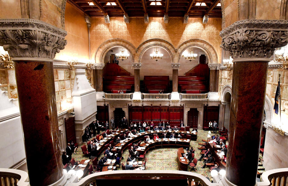 Members of the New York state Senate debate budget bills during session in Senate Chamber at the state Capitol Sunday, March, 31, 2019, in Albany, N.Y. (AP Photo/Hans Pennink)