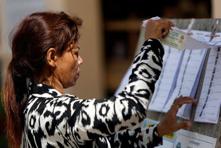 A voter looks at a voters list during a general election in Phnom Penh, Cambodia July 29, 2018. REUTERS/Samrang Pring