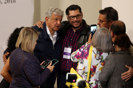Leftist front-runner Andres Manuel Lopez Obrador of the National Regeneration Movement (MORENA) poses for a picture with invitees during the "Dialogue for Peace and Justice" at the Museum of Memory and Tolerance in Mexico City, Mexico May 8, 2018. REUTERS/Gustavo Graf
