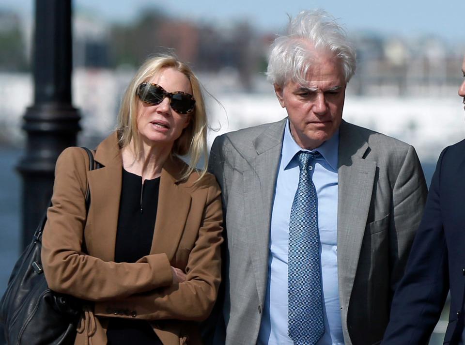 Marcia, left, and Gregory Abbott leave federal court, Wednesday, May 22, 2019, in Boston, where they pleaded guilty to charges in a nationwide college admissions bribery scandal. (AP Photo/Michael Dwyer)