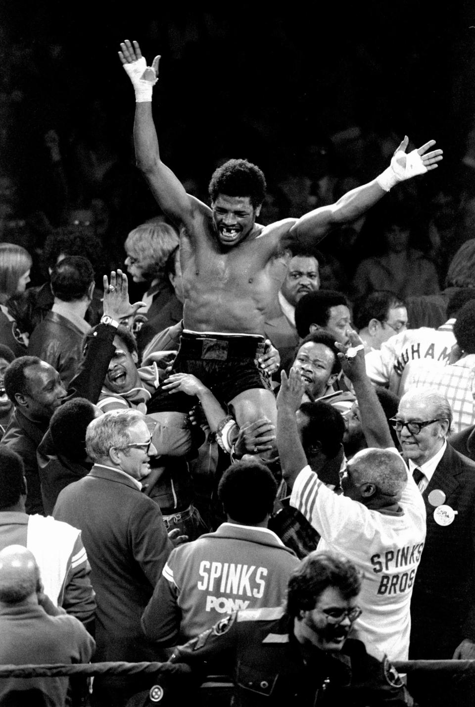 FILE - In this Feb. 15, 1978, file photo, Leon Spinks celebrates as his entourage holds him aloft after his 15-round split decision victory over world heavyweight boxing champion Muhammad Ali in Las Vegas. Former heavyweight champion Leon Spinks Jr. died Friday night, Feb. 5, 2021, after battling prostate and other cancers. He was 67. (AP Photo/Lenny Ignelzi, File)