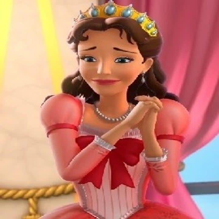 Queen Miranda from Disney's Sofia the First with a slight smile and hands folded near her chin