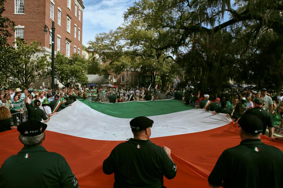 A group marches with a large Irish Flag during the Savannah St. Patrick's Day Parade on Saturday, March 16, 2024.