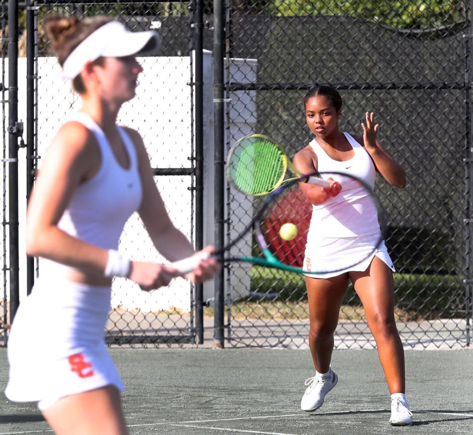 Spruce Creek's Giselle Adekunle hits a shot during a doubles match with teammate Kayla Wheeler in the District 2-4A Tournament, Tuesday, April 16, 2024, at the Palm Coast Tennis Center.