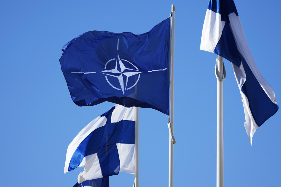 NATO flag, centre, and Finland flags flutter over the building of Ministry of Foreign Affairs in Helsinki, Finland, Tuesday, April 4, 2023. Finland prepared to make its historic entry into NATO Tuesday, a step that doubles the Western alliance’s border with Russia and ends decades of non-alignment for the Nordic nation. (AP Photo/Sergei Grits)