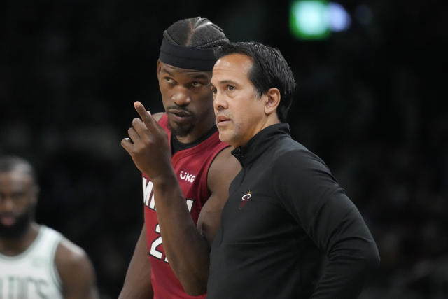 Miami Heat forward Jimmy Butler, left, talks with head coach Erik Spoelstra, right, during the first half of Game 2 of the NBA basketball playoffs Eastern Conference finals against the Boston Celtics in Boston, Friday, May 19, 2023. (AP Photo/Charles Krupa)