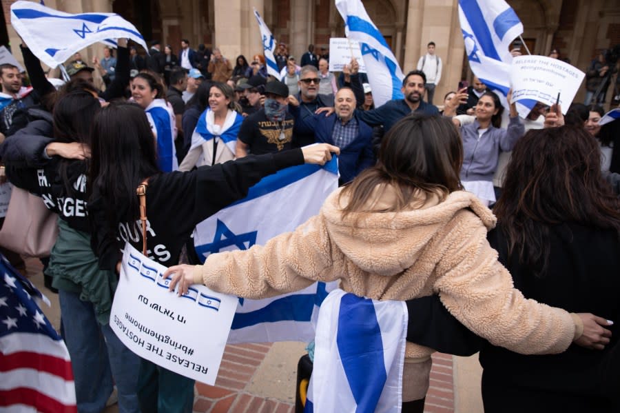 LOS ANGELES, CALIFORNIA – APRIL 25: A group of Israeli, holding flags and banners, face against Pro-Palestinian students as they gather to protest against Israeli attacks on Gaza at University of California (UCLA) in Los Angeles, California, United States on April 25, 2024. (Photo by Grace Hie Yoon/Anadolu via Getty Images)