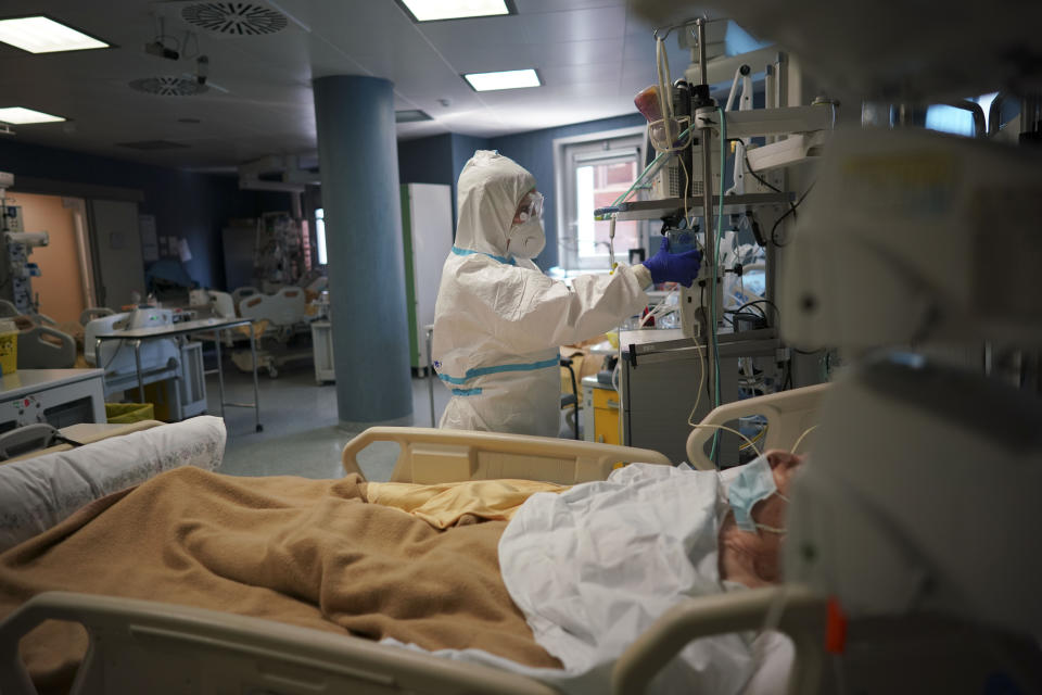 Medical staff tends to a patient in the ICU unit of Rome's San Filippo Neri Hospital's Covid department, in Rome, Thursday, April 9, 2020. The new coronavirus causes mild or moderate symptoms for most people, but for some, especially older adults and people with existing health problems, it can cause more severe illness or death. (AP Photo/Andrew Medichini)