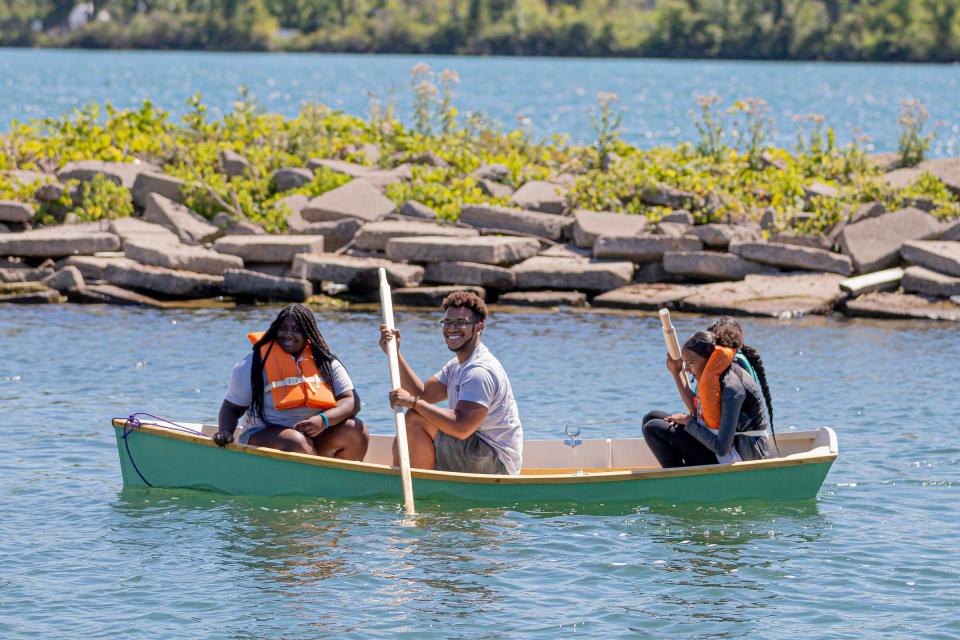 Jewell Marsh, 15, of Ferndale, Ian Price, 23, of West Side, Leeanna Jackson, 14, of Novi, and Mariah Vaughn, 14, of Detroit, travel in the boats they have built for the first time in the Detroit River built during the Detroit River Skiff and Schooner Program, at the Riverside Marina on Aug. 12, 2022.