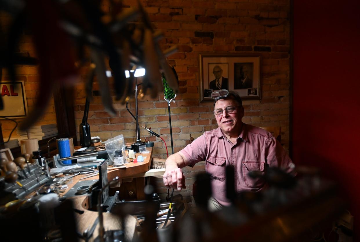 Stewart Powell, of Linn & Owen Jewelers in downtown Lansing, poses for a portrait at his work bench Wednesday, Jan. 31, 2024.