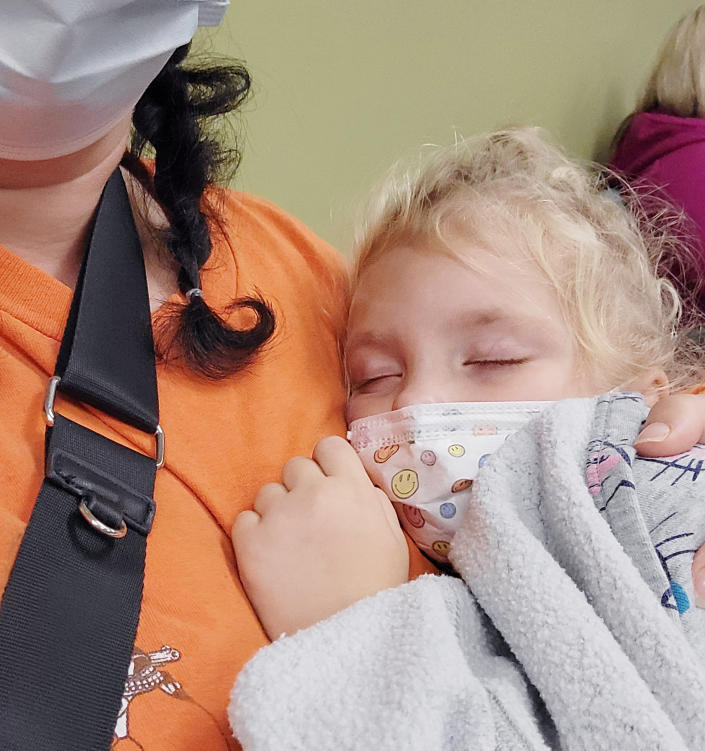 Shelby Templin holds her 4-year-old daughter upright so she can breathe while waiting to be treated. (Courtesy Shelby Templin)