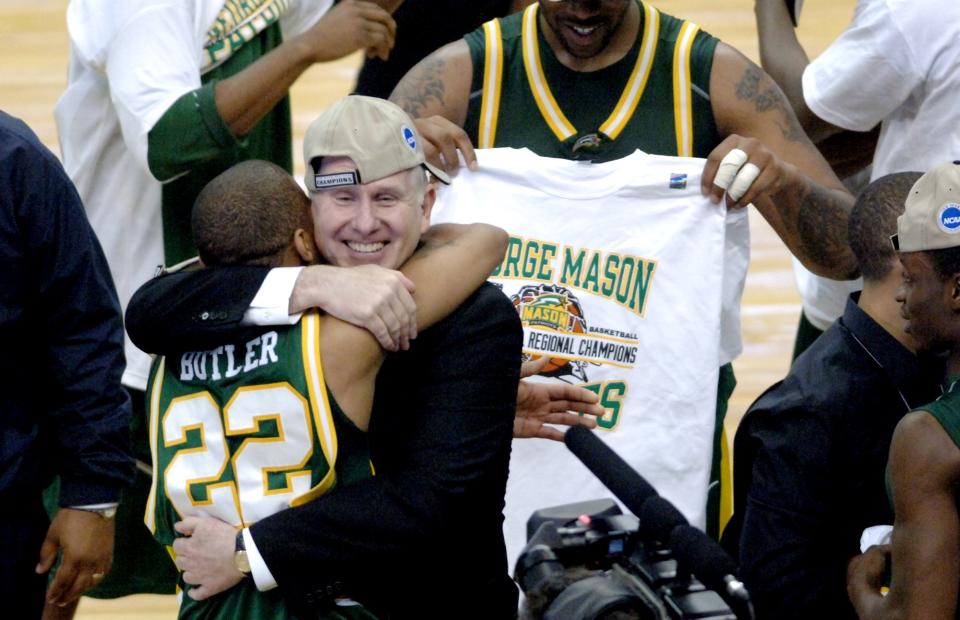 George Mason's head coach Jim Larranaga hugs Lamar Butler after the Patriots defeated Connecticut 86-84 during the NCAA regional finals at the Verizon Center in Washington, D.C. on Sunday, March 26, 2006.  (Photo by Steve Deslich/MCT/Tribune News Service via Getty Images)