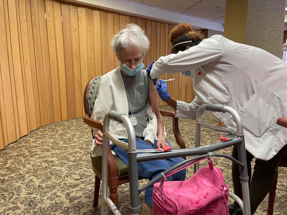 A Topeka Presbyterian Manor resident receives her first round of the Pfizer vaccine against COVID-19 on Saturday. Nursing homes, which have been hit particularly hard by the coronavirus, have priority status in receiving the vaccine.