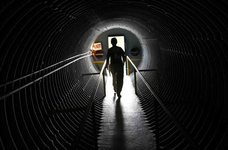 Curator Ruth Pelletier walks down a hallway in the cold-war era nuclear fallout shelter constructed for President John F. Kennedy on Peanut Island near Riviera Beach, Florida November 8, 2013. REUTERS/Joe Skipper