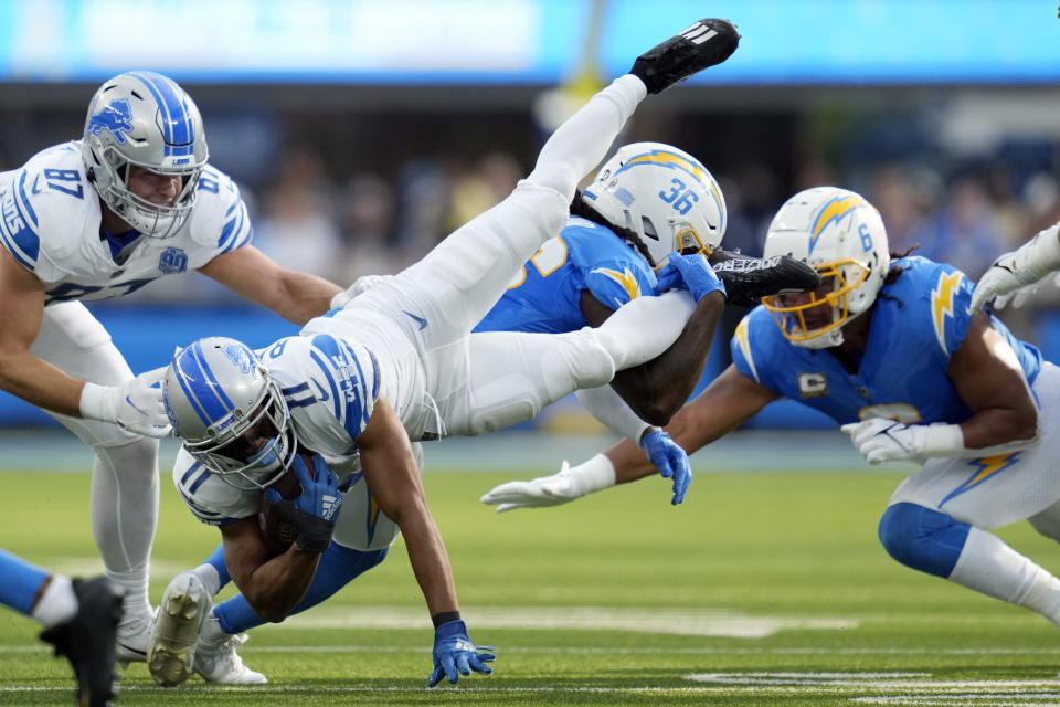 Detroit Lions wide receiver Kalif Raymond (11) is tackled by Los Angeles Chargers cornerback Ja'Sir Taylor (36) during the first half an NFL football game Sunday, Nov. 12, 2023, in Inglewood, Calif. (AP Photo/Ashley Landis)
