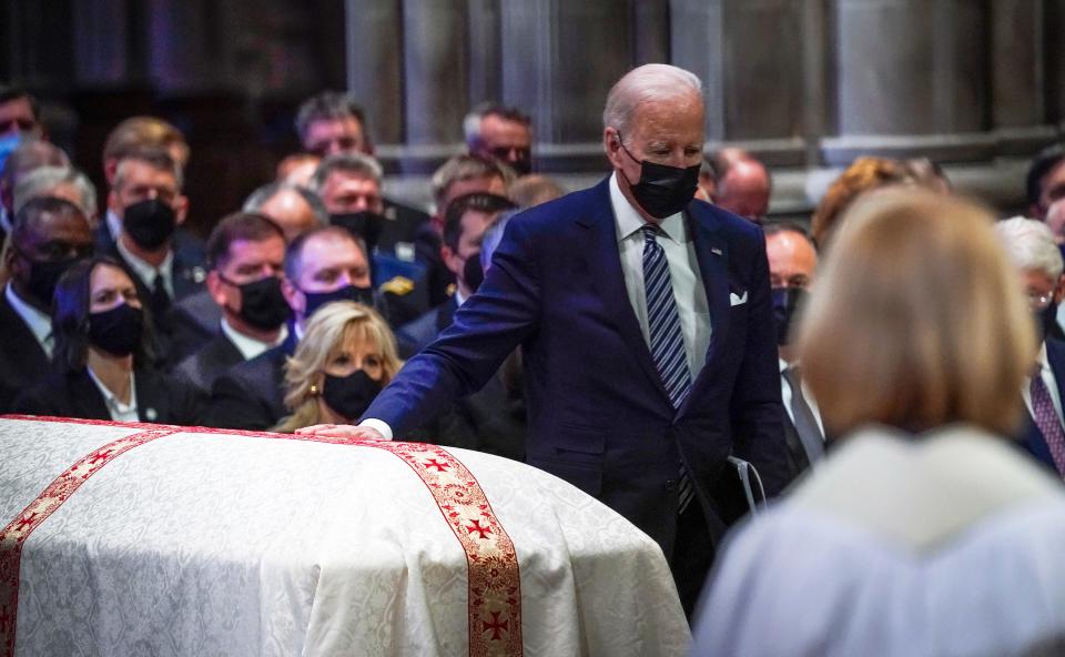 President Joe Biden places his hand on Sen. Bob Dole’s casket at the former senator's funeral service at Washington National Cathedral.