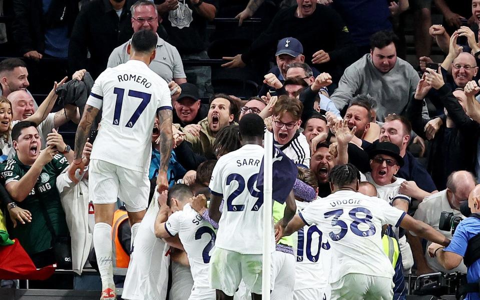 Tottenham Hotspur players and fans celebrate their second goal an own goal scored by Liverpool's Joel Matip