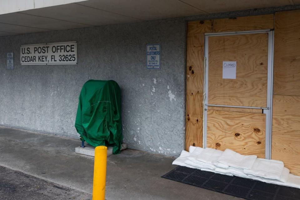 The U.S. Post Office in Cedar Key, Florida, is boarded up in anticipation of Hurricane Idalia.