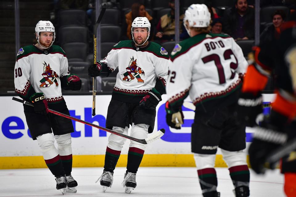 Arizona Coyotes left wing Nick Ritchie (12) celebrates his goal scored against the Anaheim Ducks with defenseman J.J. Moser (90) and center Travis Boyd (72) during the first period at Honda Center on Jan. 28, 2023, in Anaheim.