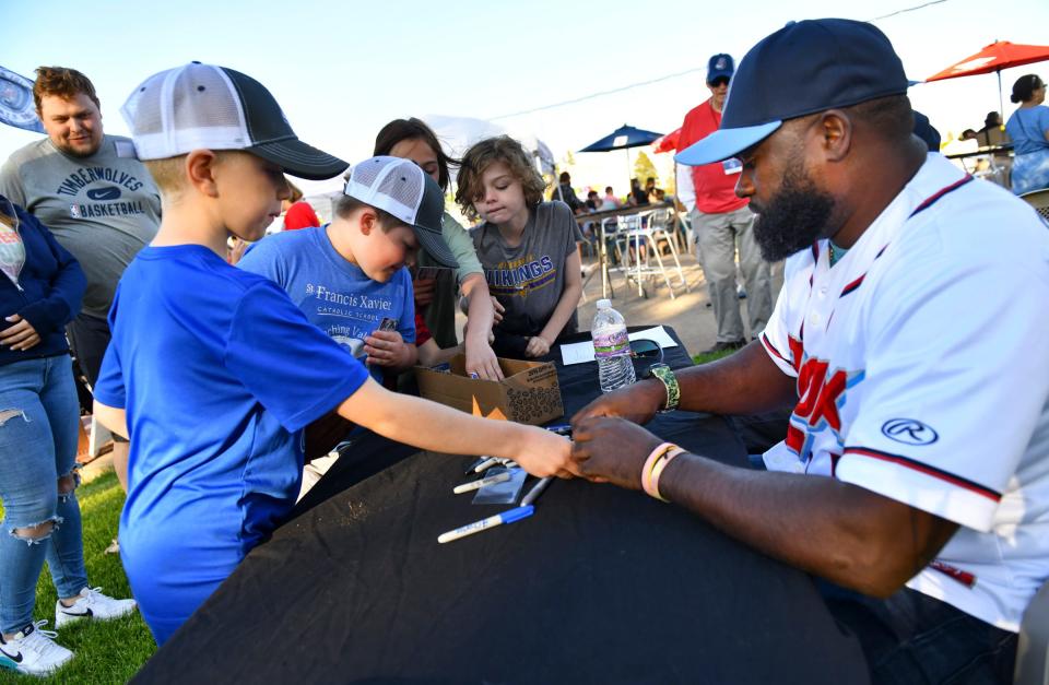 Former Minnesota Twins shortstop Cristian Guzman signs autographs for young fans during the Rox home opener Friday, June 3, 2022, at Joe Faber Field in St. Cloud.