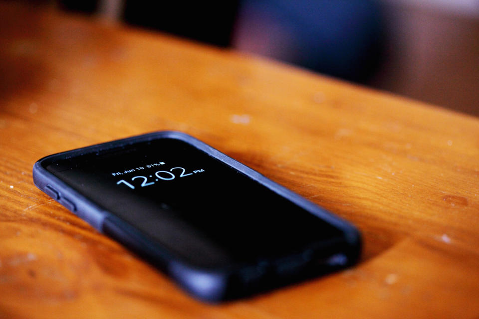 A phone sitting on a coffee table.