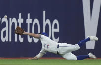 Toronto Blue Jays outfielder Davis Schneider makes a diving catch on a ball hit by New York Yankees' Anthony Rizzo during the sixth inning of a baseball game Tuesday, April 16, 2024, in Toronto. (Nathan Denette/The Canadian Press via AP)