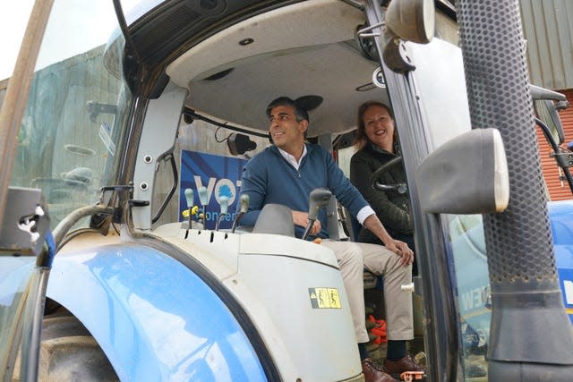 Rishi Sunak and Victoria Prentis in a tractor, Banbury