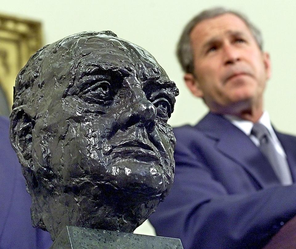 <p>George W Bush received the bust of Sir Winston Churchill from the British Ambassador in 2001</p> (AFP via Getty Images)