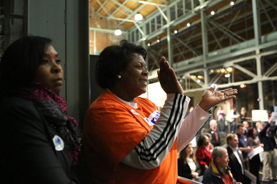 Carolyn Tandy, district director for U.S. Rep. John Yarmuth, claps as Alison Lundergan Grimes campaigns in Louisville on the eve of the U.S. Senate election. Nov. 3, 2014. 