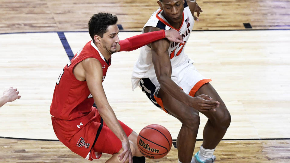 Davide Moretti of the Texas Tech Red Raiders is defended by DeAndre Hunter during the 2019 NCAA men’s Final Four National Championship game. (Photo by Hannah Foslien/Getty Images)