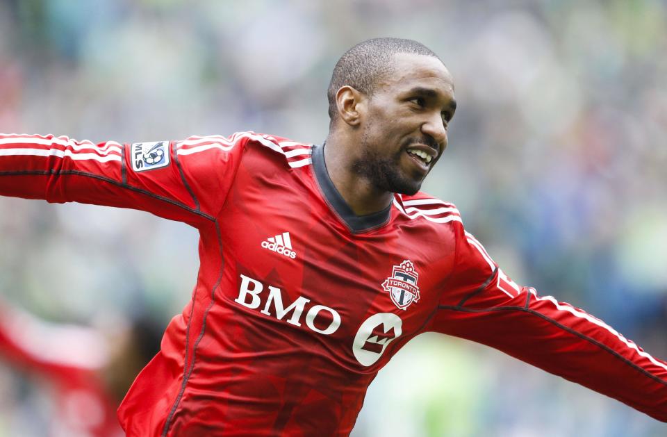 Mar 15, 2014; Seattle, WA, USA; Toronto FC forward Jermain Defoe (18) celebrates his goal against the Seattle Sounders FC during the first half at CenturyLink Field. (Joe Nicholson-USA TODAY Sports)