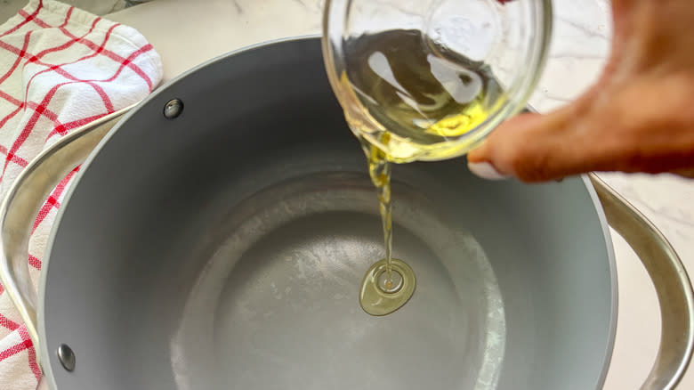 adding oil to pot