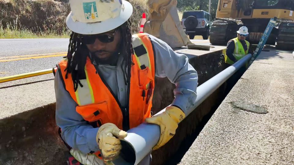 Aaron Morgan, with Pacific Gas & Electric Co., works to install underground power lines in Sonoma County, California, on Monday, June 13, 2022. - Haven Daley/AP