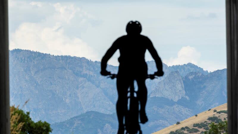 A cyclist rides along a trail near the Potato Hill Trailhead of Corner Canyon in Draper on Thursday, July 18, 2024.