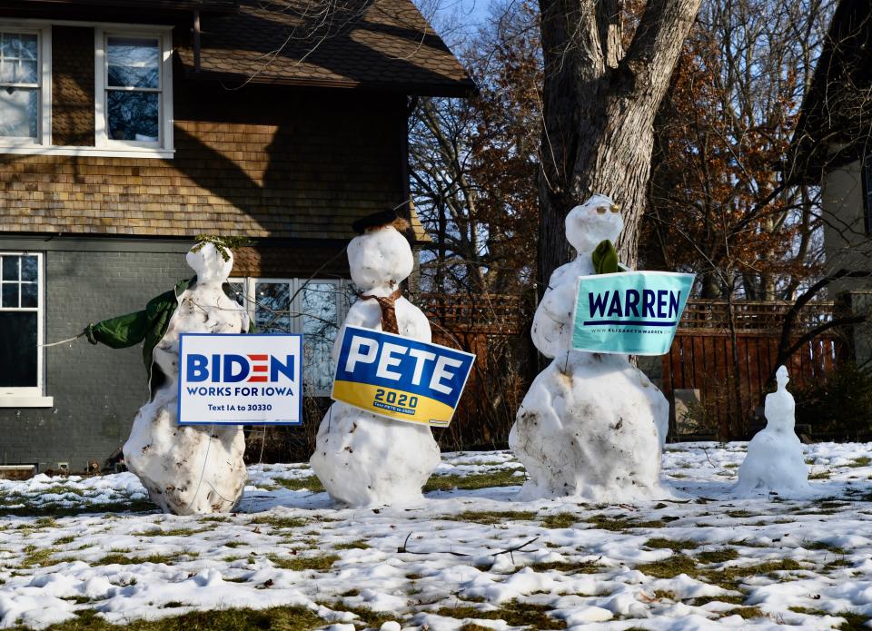 Snowmen dressed as Democratic presidential candidates former Vice President Joe Biden, left, former South Bend, Indiana, Mayor Pete Buttigieg and U.S. Sen. Elizabeth Warren of Massachusetts stand guard in one Des Moines yard on caucus day, Feb. 3, 2020.