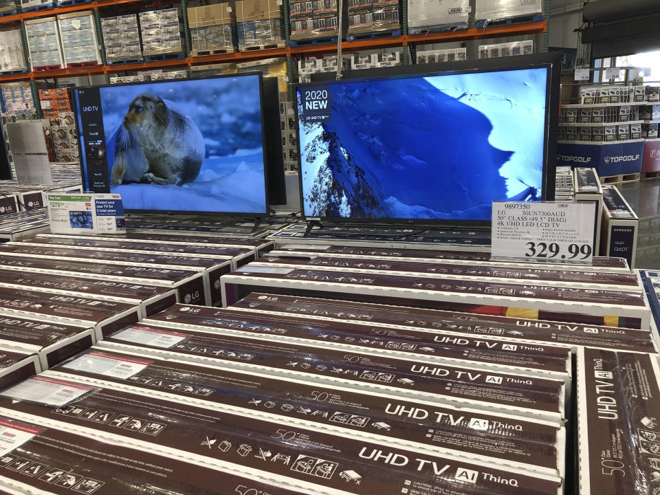 Rows of boxed big-screen televisions sit on display at a Costco warehouse in this photograph taken Wednesday, Nov. 18, 2020, in Sheridan, Colo. Orders for big-ticket manufactured goods slow to modest gain of 1.3% in October indicating economy is slowing. (AP Photo/David Zalubowski)