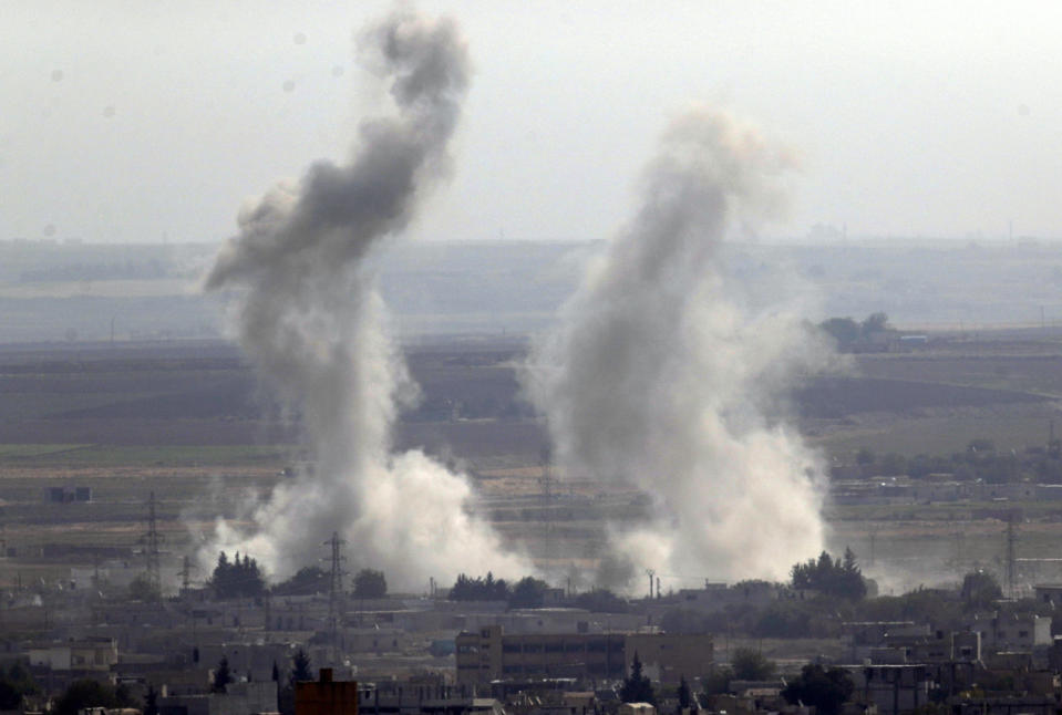 In this photo taken from the Turkish side of the border between Turkey and Syria, in Ceylanpinar, Sanliurfa province, southeastern Turkey, smoke and dust billows from targets in Ras al-Ayn, Syria, caused by bombardment by Turkish forces, Tuesday, Oct. 15, 2019. Turkish artillery on Tuesday pounded suspected Syrian Kurdish positions near the town in northeast Syria amid reports that Kurdish fighters had retaken the town as Turkey pressed ahead with a military incursion that has drawn widespread condemnation. (AP Photo/Cavit Ozgul)