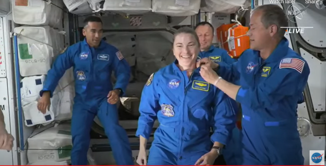 NASA astronaut Kayla Barron received her pin as a NASA astronaut who has flown in space from astronaut Tom Marshburn shortly after boarding the International Space Station on Nov. 12, 2021.