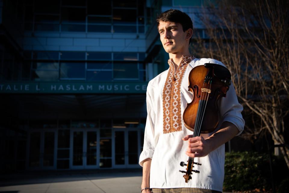 University of Tennessee violin performance student Marki Lukyniuk is photographed in front of the Natalie L. Haslam Music Center on campus on Thursday, Dec. 15, 2022. Marki, 22, arrived at UT from Ukraine in September to continue his studies while Ukraine continued to battle a war sparked by RussiaÕs February invasion.