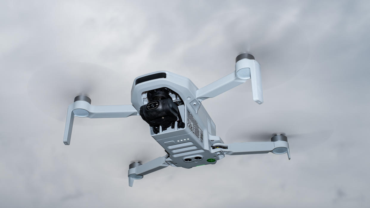  Potensic Atom drone in flight against overcast sky. 