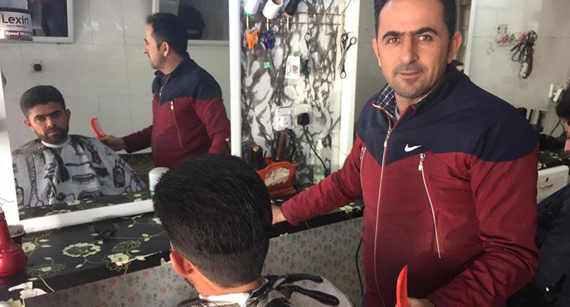 Back in business: A local barber offers haircuts after years of Islamic State rule