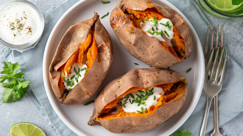 Three baked sweet potatoes on plate 