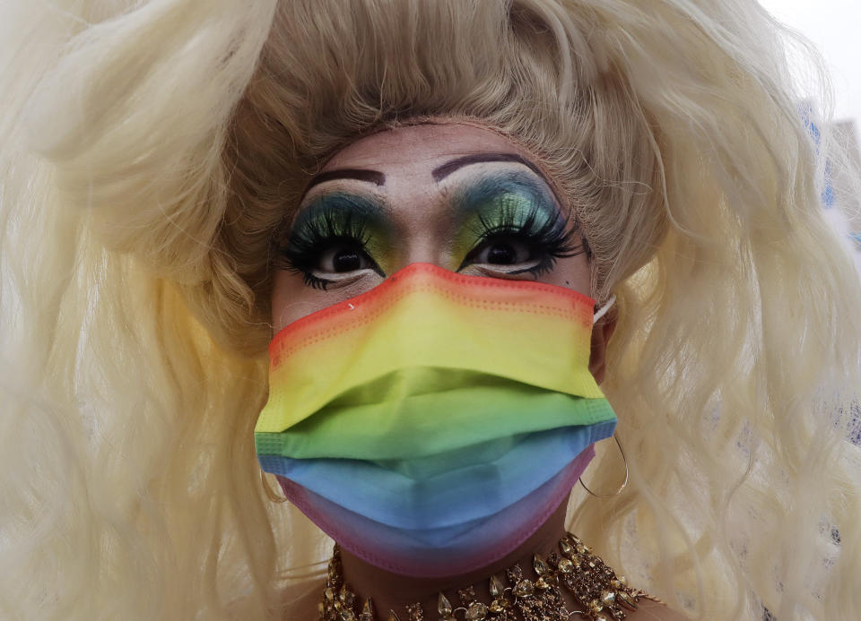 A participant wears a rainbow-patterned mask to protect against the spread of COVID-19 during the annual Taiwan LGBT Pride parade in Taipei, Taiwan, Saturday, Oct. 29, 2022. (AP Photo/Chiang Ying-ying)