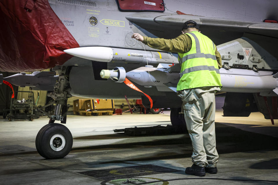 In this image provided by the UK Ministry of Defence, RAF Armourers (Weapon Technicians) prepare a Royal Air Force Typhoon FGR4 for air strikes against Houthi military targets in Yemen, in RAF Akrotiri, Sunday, Jan. 21, 2024. The U.S. and British militaries bombed eight locations used by the Iranian-backed Houthis in Yemen on Monday night, the second time the two allies have conducted coordinated retaliatory strikes on an array of the rebels' missile-launching capabilities. (AS1 Leah Jones/Ministry of Defence via AP)